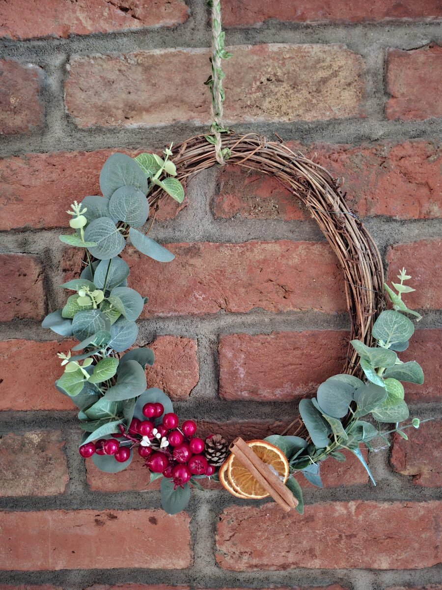 Loza, eukaliptus: Vijenac od loze s eukaliptusom u polumjesecu, grozdom crvenih bobica i kriškom suhe naranče s cimetom....